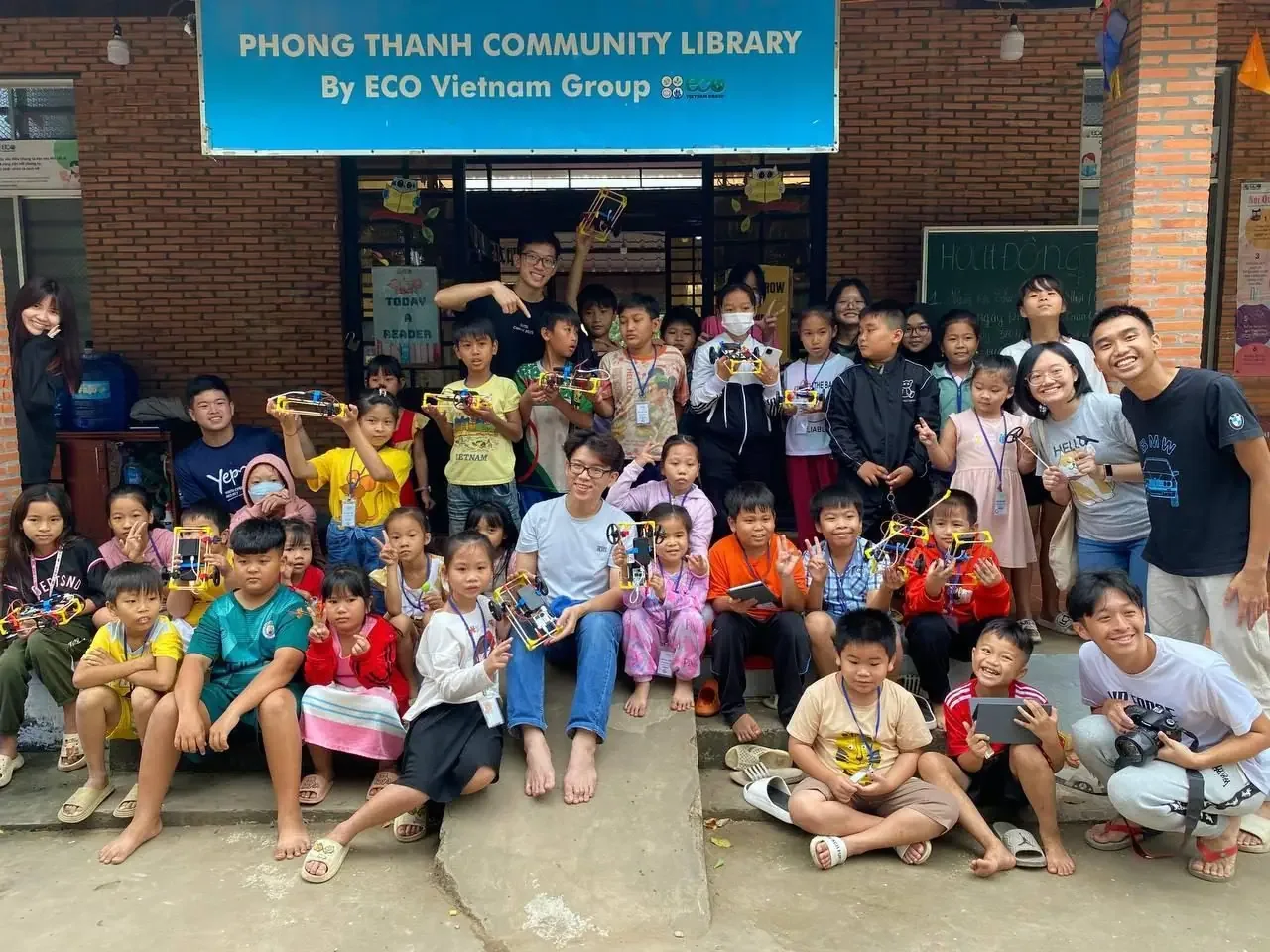 A whole community group in Vietnam, every child holding their build