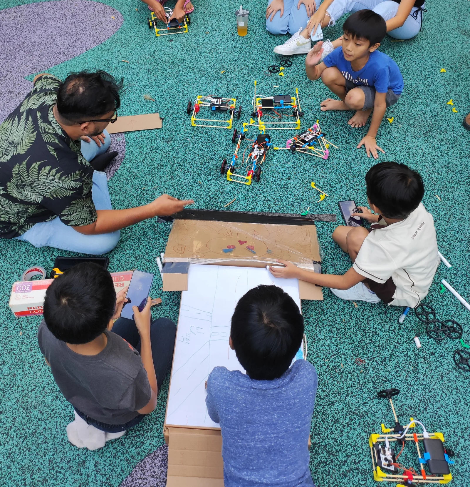Children building together on the ground outdoors