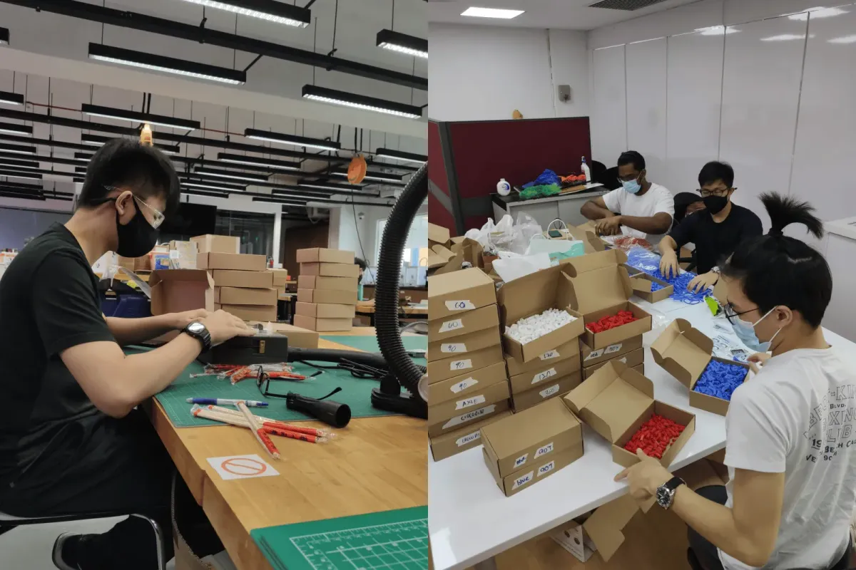 Early production by hand: one person cutting chopsticks at a workbench, three people filling boxes on the floor